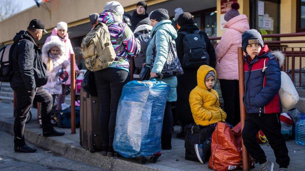 Refugees from Ukraine wait for further transportation at Polish railway station