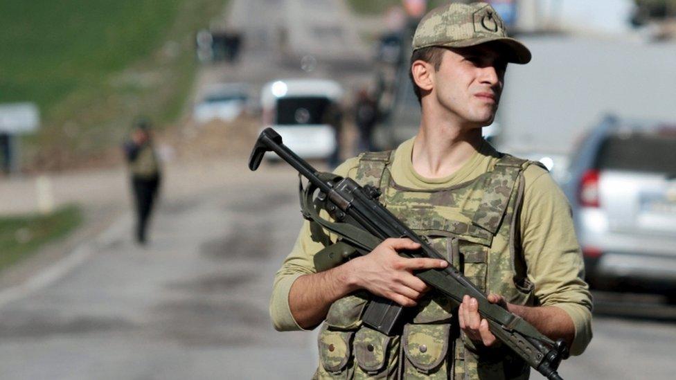 A Turkish soldier stands guard in Diyarbakir, 18 February 2016