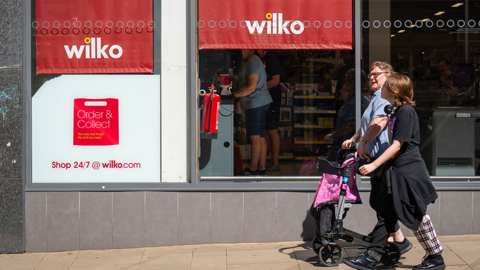 People walk in front of Wilko shop