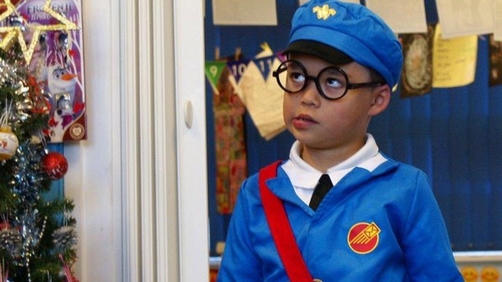 boy dressed as postman