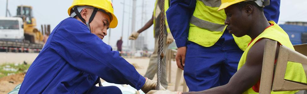 Chinese and Ivorian workers in Abidjan, Ivory Coast - July 2015