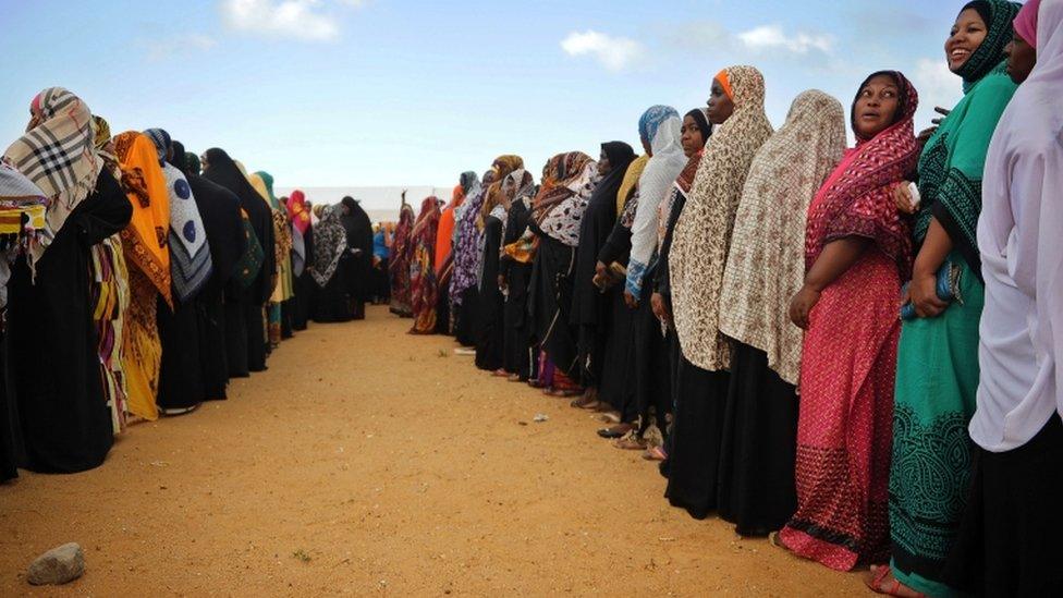 Tanzanian women queue to cast his ballot at a polling station on October 25, 2015 in Zanzibar