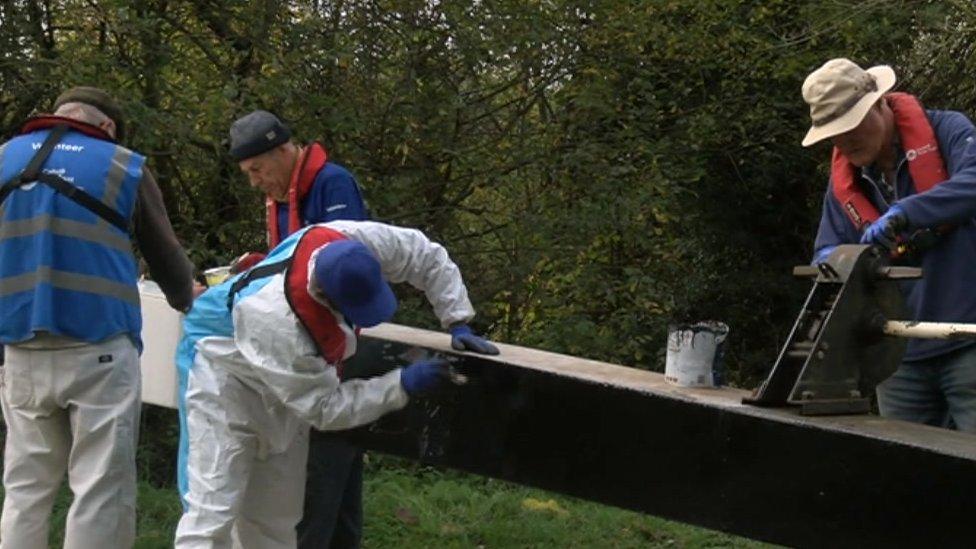 volunteers painting a bridge