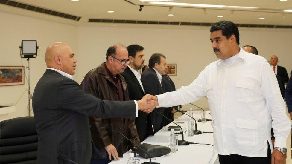 President Nicolas Maduro (R) shakes hands with Jesus Torrealba (L), secretary of Venezuela's coalition of opposition parties (MUD), during a political meeting between government and opposition, in Caracas, Venezuela October 30, 2016.
