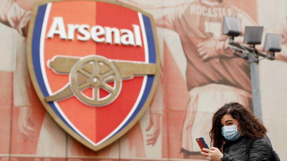 Woman in mask outside emirates