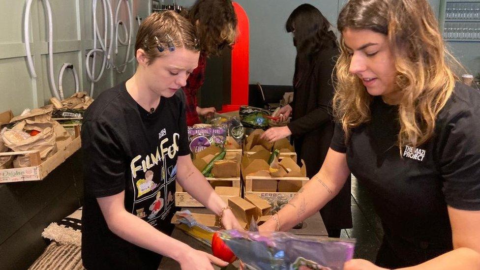 Maisie Williams helping to fill a food box