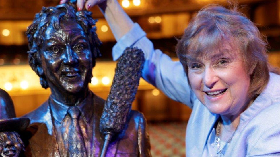 Lady Anne Dodd with sculpture of Sir Ken Dodd