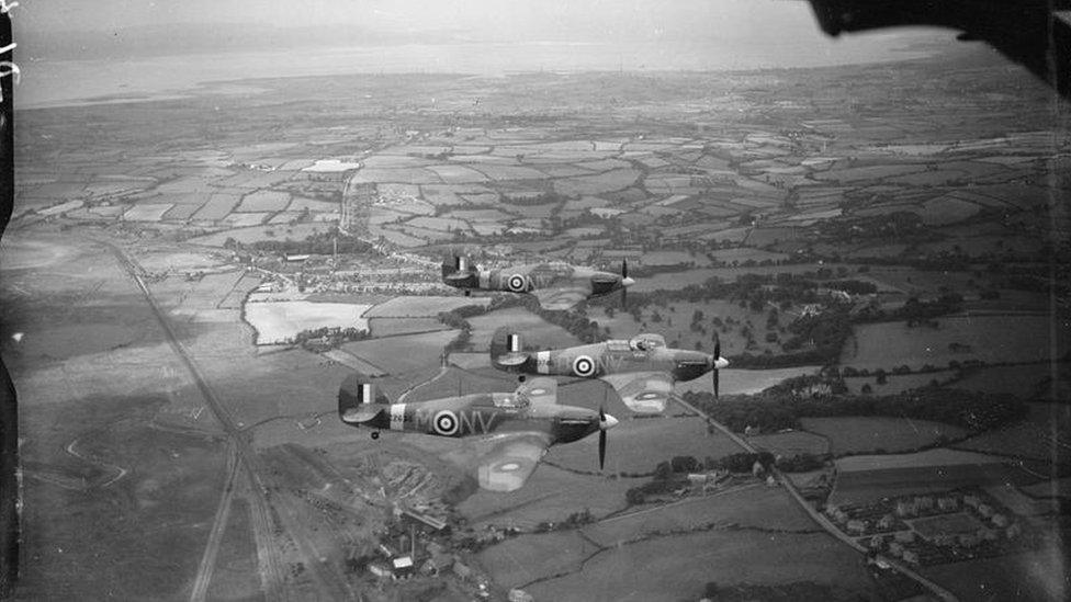 Three Hawker Hurricane Mark IIBs of No 79 Squadron RAF based at Fairwood Common during WW2 flying above south Wales