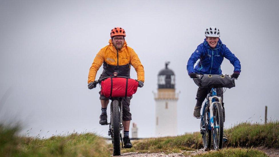 Two cyclists at Cape Wrath