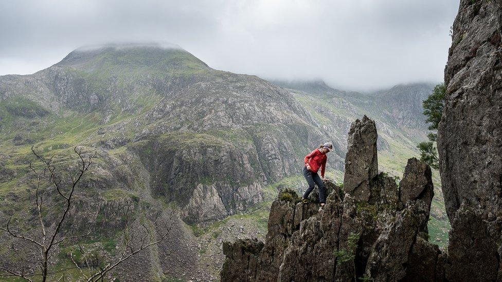 Anna Taylor climbing a mountain in Wales