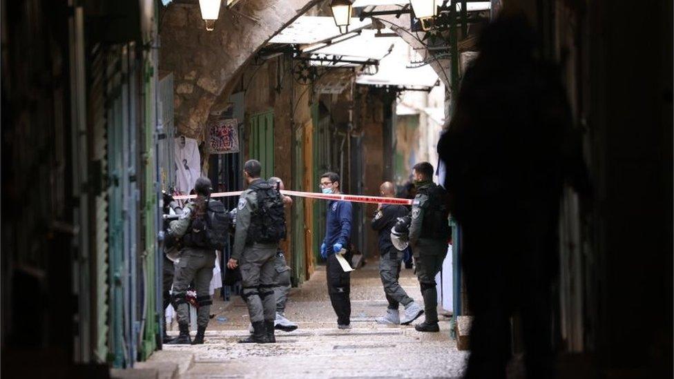 Israeli security officials inspect the scene of the shooting attack next to the Chain gate that leads to Al Aqsa compound in Jerusalem"s old city