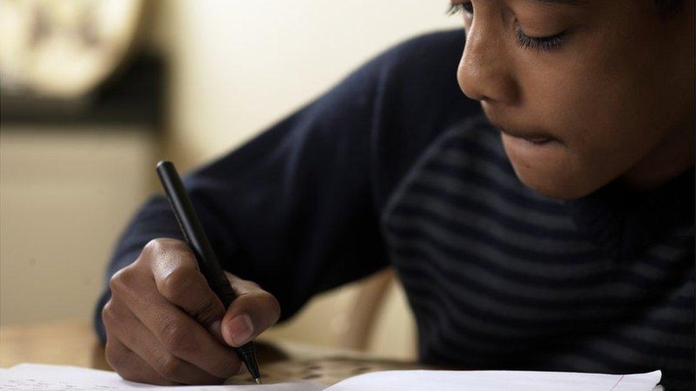 Boy writing an exam