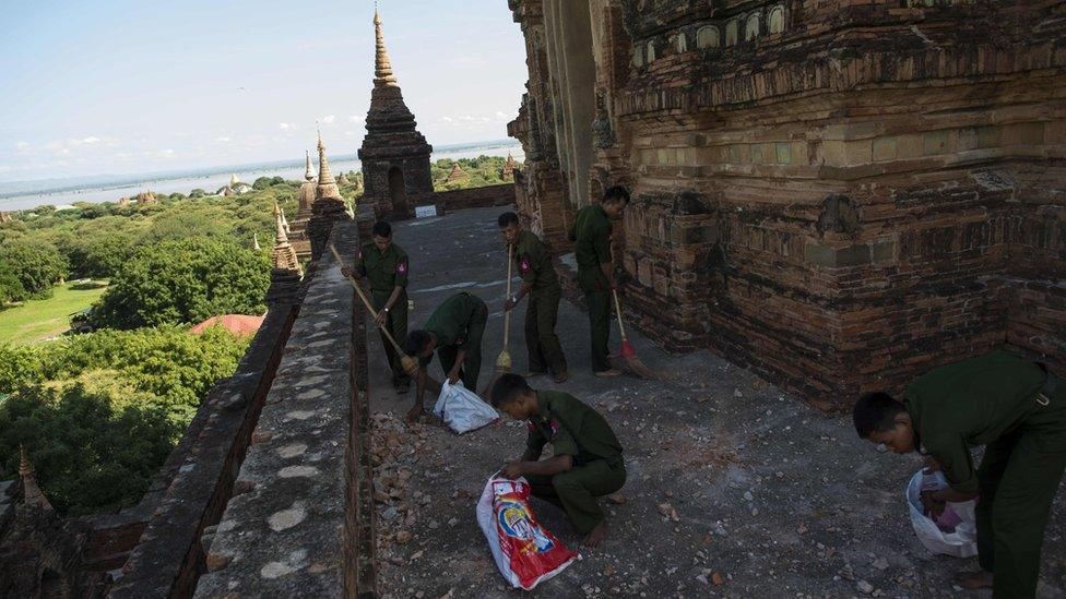 Myanmar military staff collect pieces of bricks at the damaged ancient Htilominlo Temple on 25 August 2016.