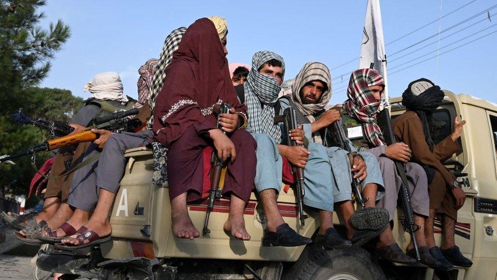 Taliban fighters in a vehicle patrol the streets of Kabul on August 23, 2021