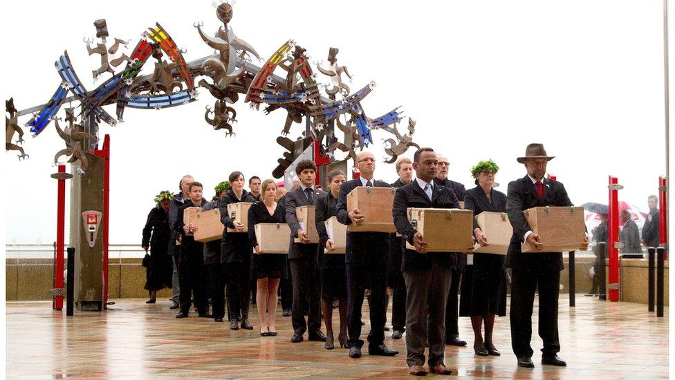 A repatriation team carries remains at a Maori welcome ceremony in 2012