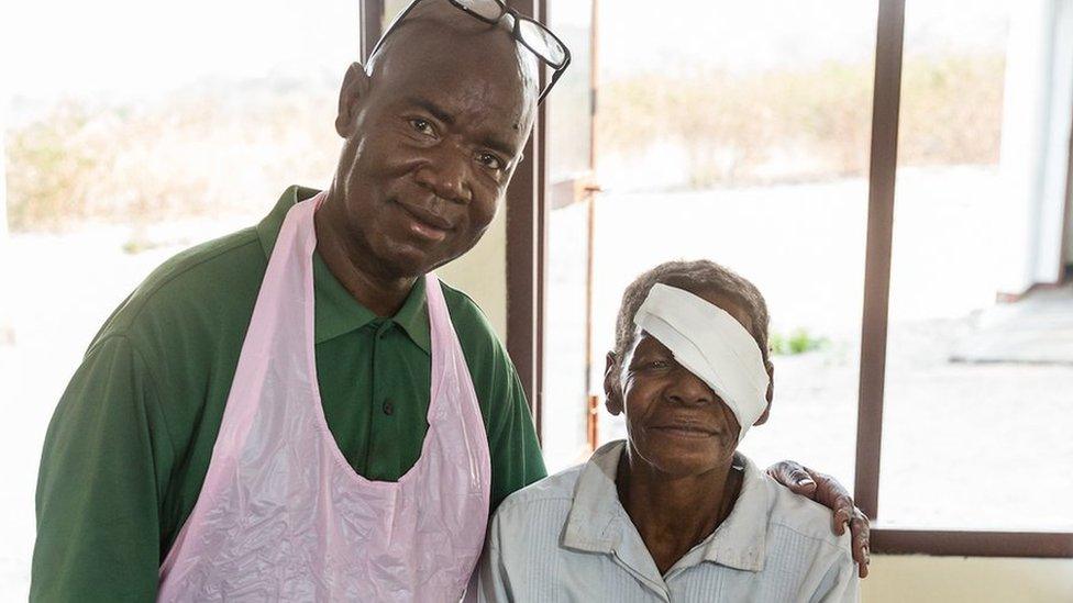 Woman and surgeon pose after the operation