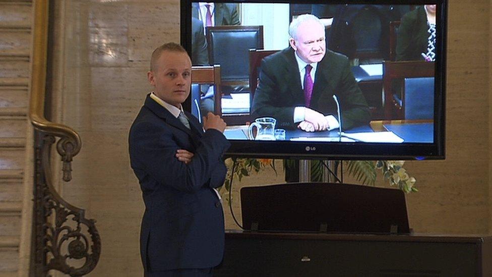 Jamie Bryson watches Martin McGuinness appearing before the committee