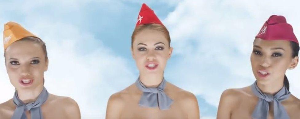 Screen shot from the video advertisement showing three naked air stewards - from the shoulders up