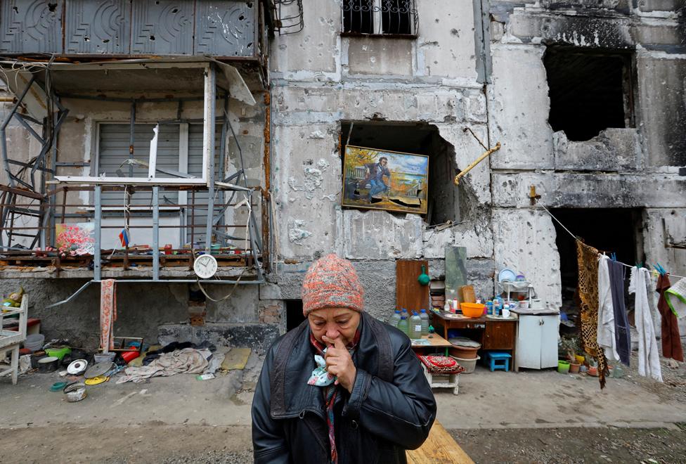 Galina Shevtsova outside the apartment building where she lives in the basement with her husband Pavel, after their flat was destroyed in March 2022 in the course of Russia-Ukraine conflict, in Mariupol, Russian-controlled Ukraine, November 16, 2022.