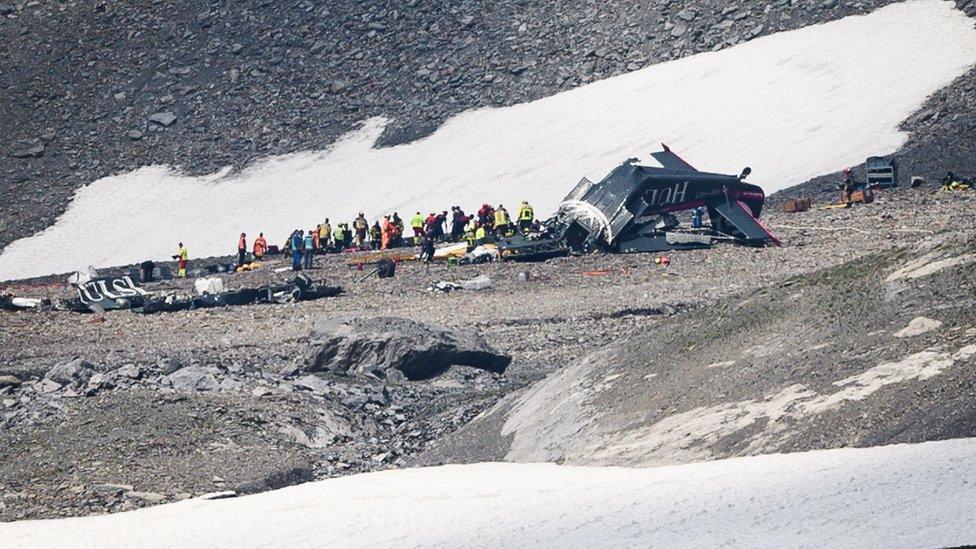 Accident investigators and rescue personnel work at the wreckage of a Junkers JU52 aircraft in Flims in eastern Switzerland on 5 August 2018.