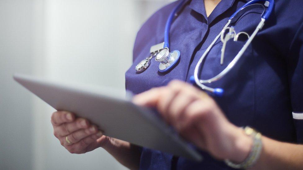 Stock image of a doctor with an iPad