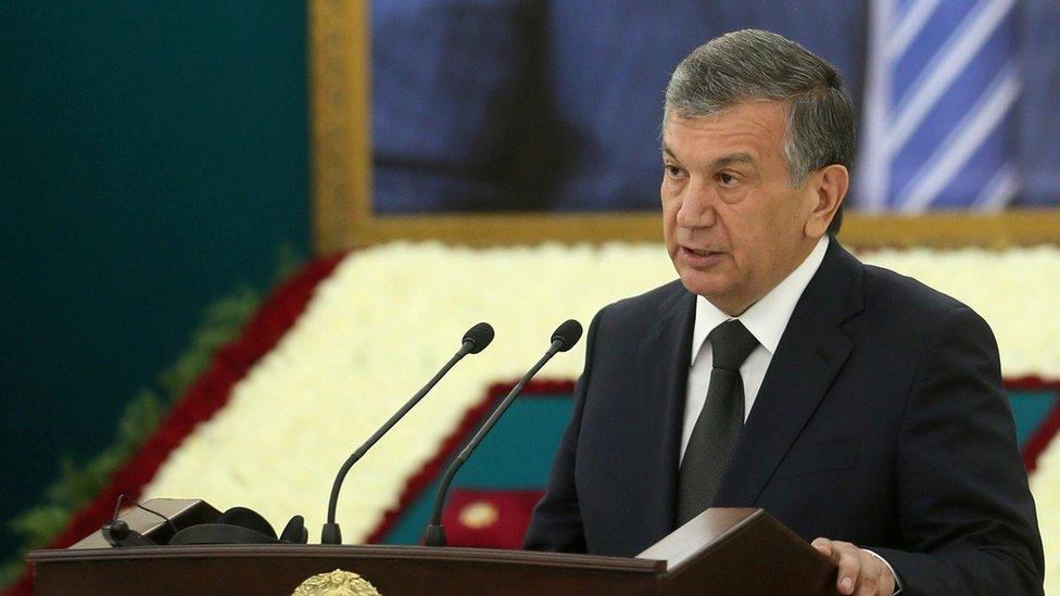 Uzbek Prime Minister Shavkat Mirziyoyev delivers a speech near a portrait of late President Islam Karimov during a mourning ceremony in Samarkand, Uzbekistan, September 3, 2016.