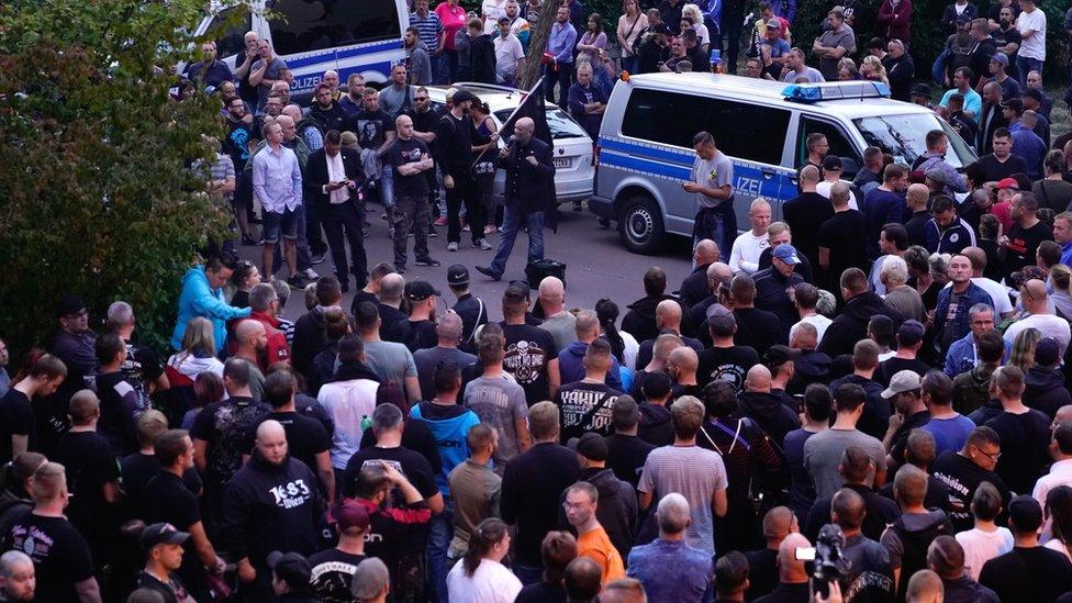 People gather in the German city of Köthen after a 22-year-old man died following a street fight, 9 September 2018