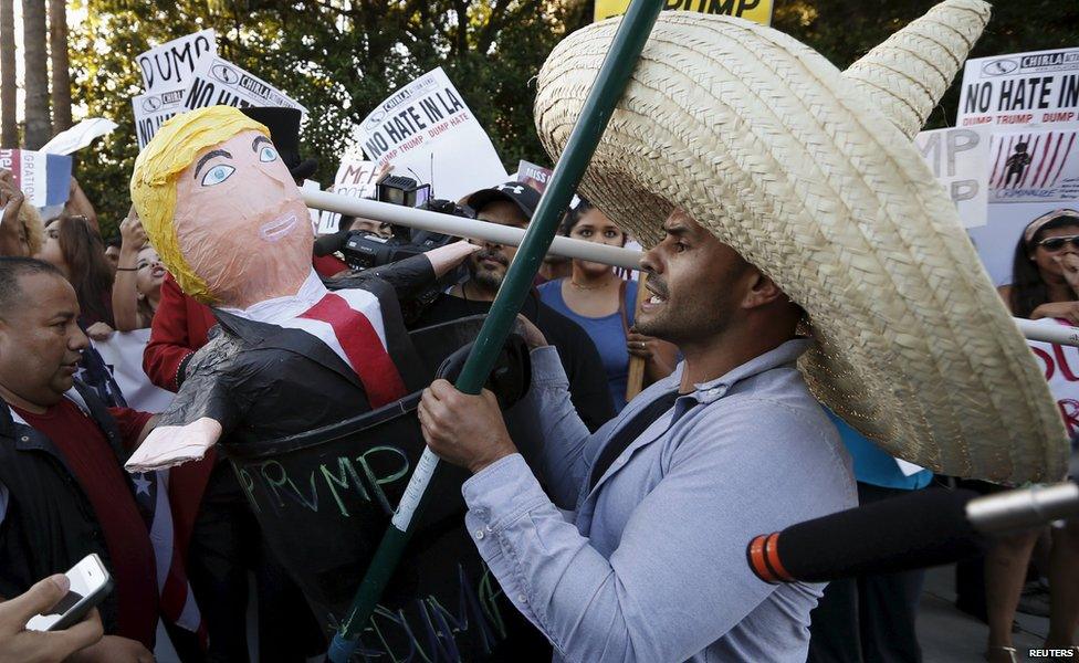 A man protests with a Donald Trump pinata in a trash can outside the Luxe Hotel, where Republican presidential candidate Donald Trump was expected to speak in Brentwood, Los Angeles, California, United States July 10, 2015.