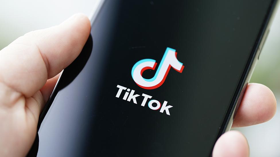 TikTok logo on phone