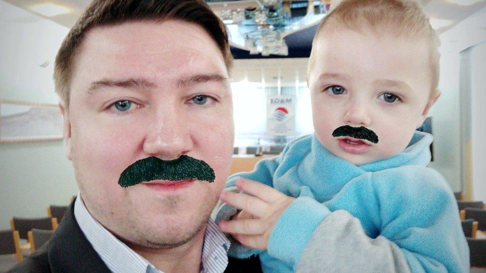 Vladimir Neupokoev and his son have moustaches drawn over their photo together