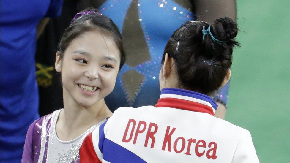 South Korea"s Lee Eun-ju, left, talks with North Korea"s Hong Un Jong during the artistic gymnastics women"s qualification the 2016 Summer Olympics in Rio de Janeiro, Brazil, Sunday, Aug. 7, 2016.