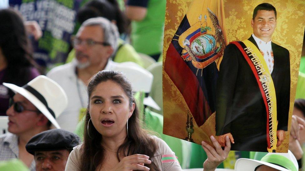 A supporter of Ecuador's former President Rafael Correa holds a poster during a convention of the Alianza Pais party in Esmeraldas, Ecuador, on 3 December 2017