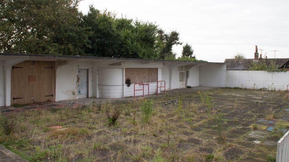 This is the food court and terrace. On the wooden covering over the window you. On the wooden covering over the window you can see a burn mark where someone had set fire to playing cards.