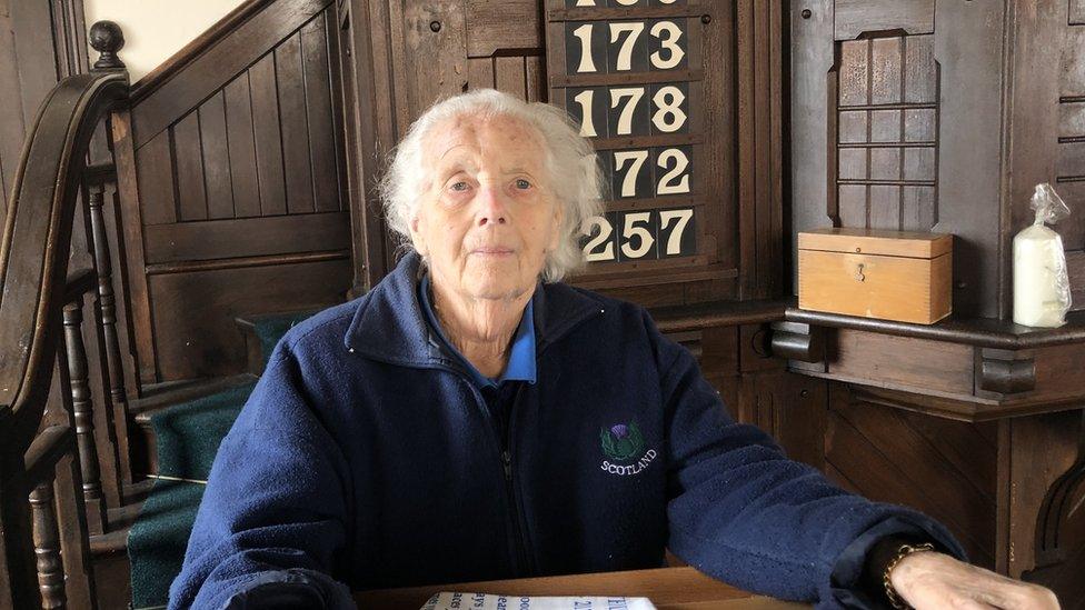 Evelyn Hamps, dressed in a navy blue fleece, sitting inside Doddington Methodist Church