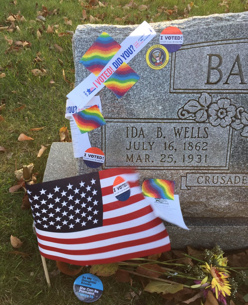 Tokens and stickers left at the grave of Ida B Wells