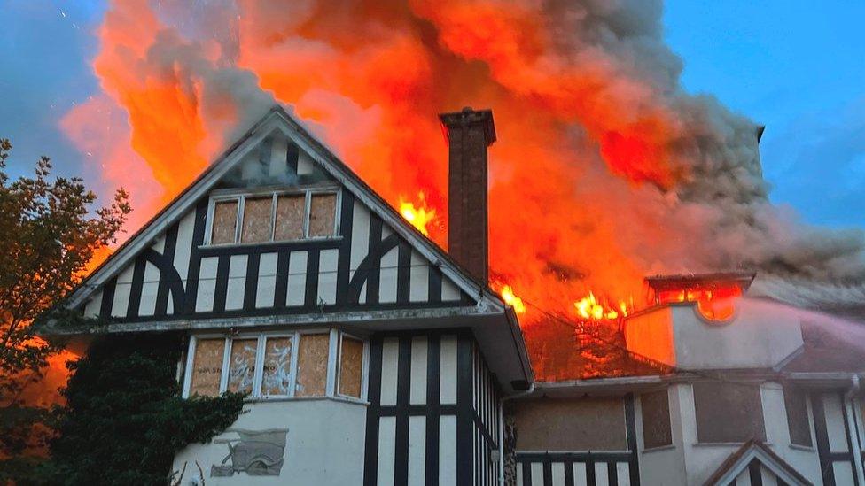 A derelict property on fire