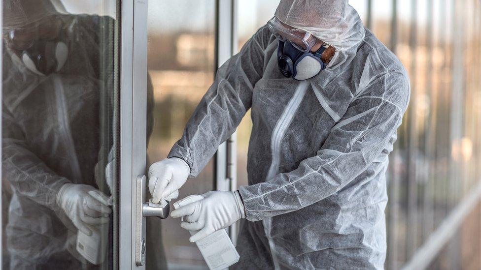 Cleaner wearing a face mask