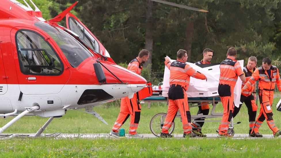 Slovak Prime Minister Robert Fico being transported from a helicopter by medics to the hospital in Banska Bystrica, Slovakia where he is to be treated after he had been shot "multiple times"