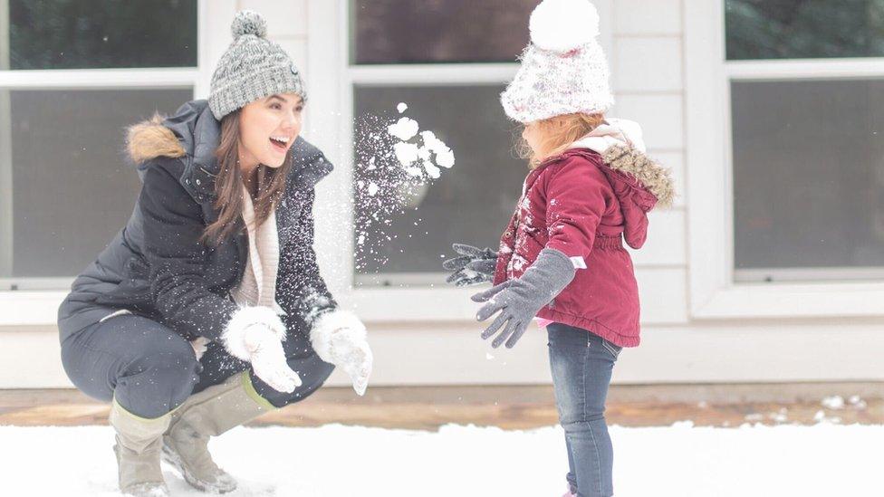 Taylor Golden - seen here in a snowball fight with her niece - says she's been "lucky" to get the lights back on