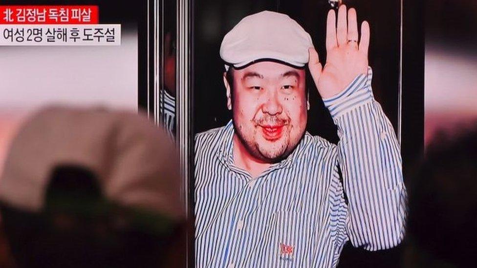 Men watch a TV screen in a train station in Seoul on 14 February 2017 showing an image of Kim Jong-nam.