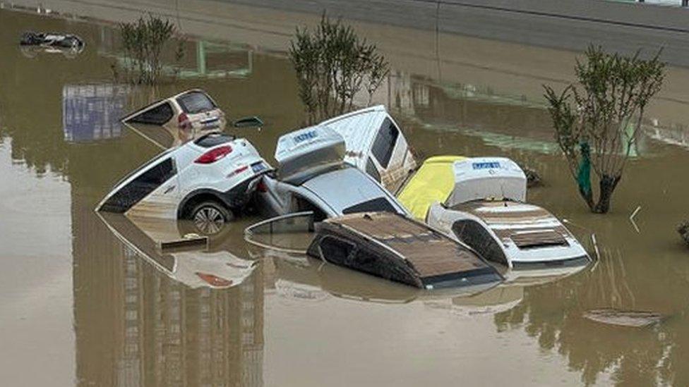 Cars sit in floodwaters after heavy rains hit the city of Zhengzhou in China's central Henan province on July 21, 2021.