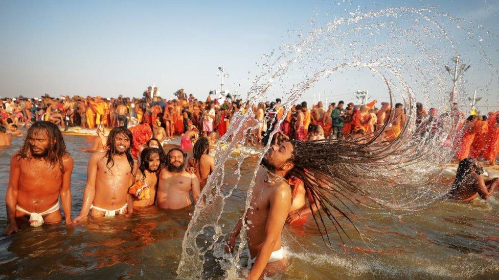 A Hindu pilgrim taking a dip at the Kumbh Mela