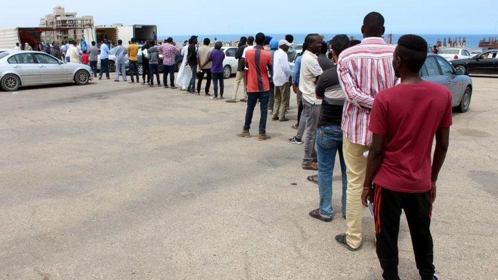 Migrants queue for food aid. Libya is a major transit point for attempts to reach Europe. File image