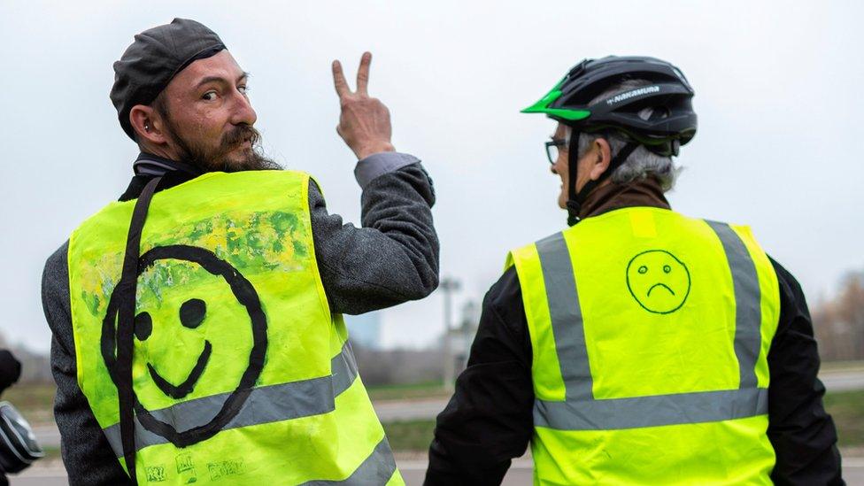 A man gestures next to a bridge over the N70 road on November 23, 2018, near Montceau-les-Mines, central France