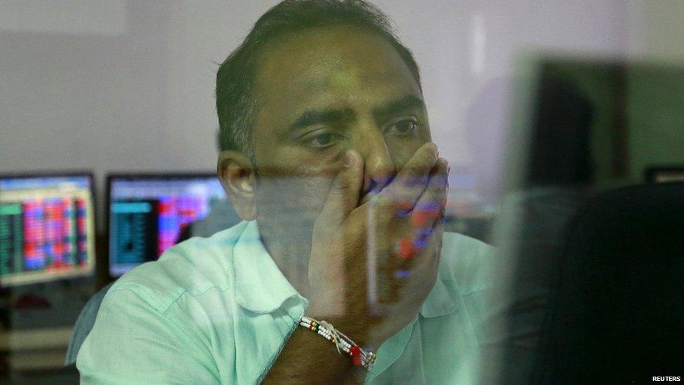 A broker at a stock brokerage firm in Mumbai, India (24 Aug 2015)