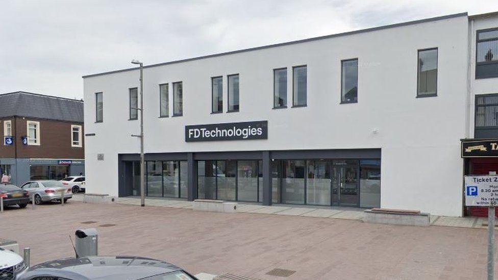 The front of FD Technologies - a white building with glass doors 