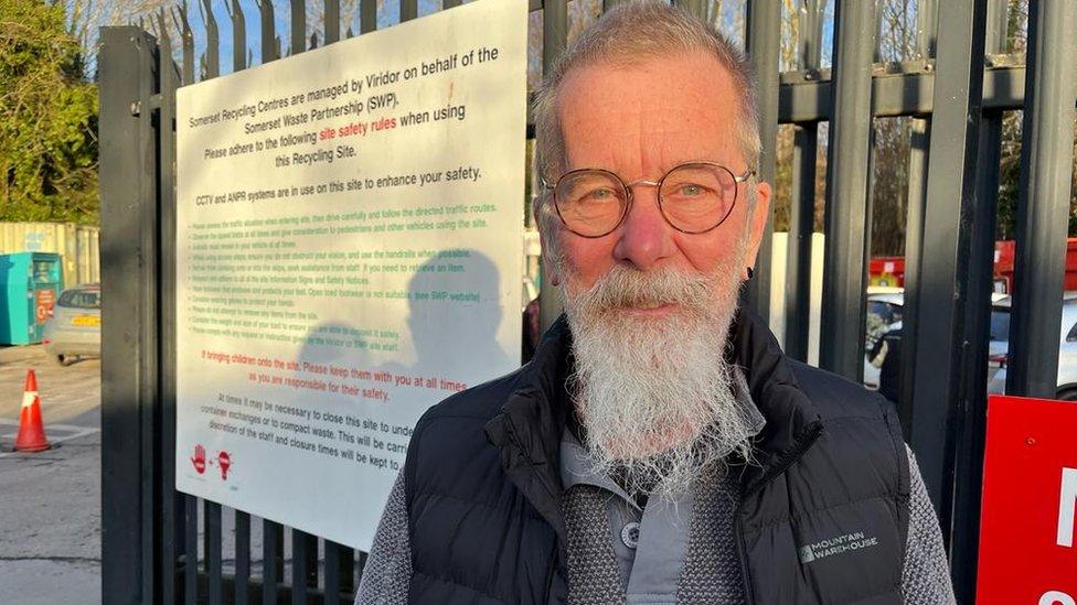 Man with beard stood in front of the recycling centre sign at Cheddar recycling centre