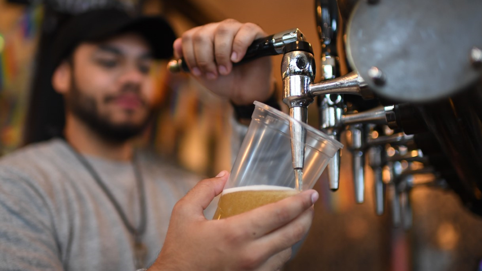 Stock image of a man pulling a pint