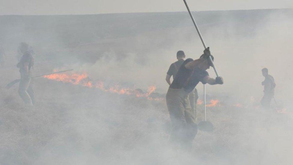 Firefighters fighting moorland fire