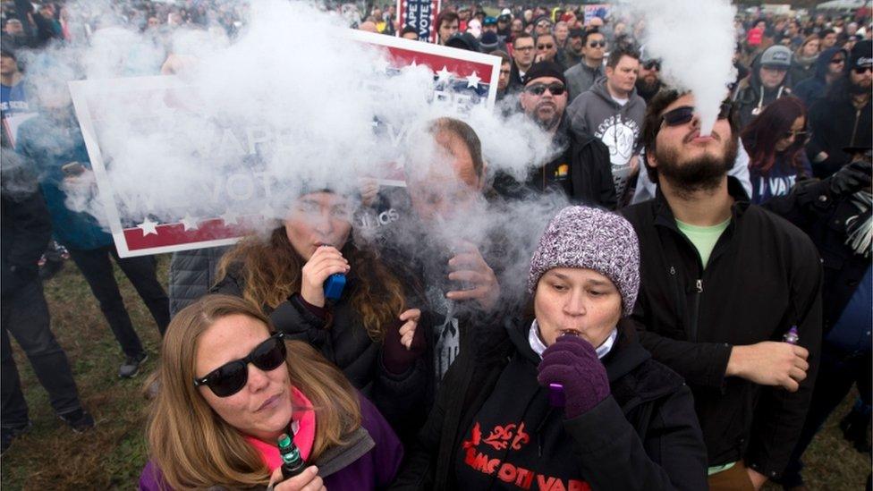 Demonstrators vape during a consumer advocate groups and vape storeowners rally outside of the White House to protest the proposed vaping flavour ban in Washington DC on 9 November 2019.